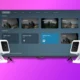 Two white security cameras are facing a colorful graphical user interface for a smart home system, which shows camera feeds and controls for various devices.