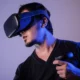 person wearing a VR headset with haptic feedback