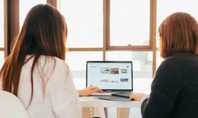 two women working on a laptop.