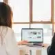 two women working on a laptop.