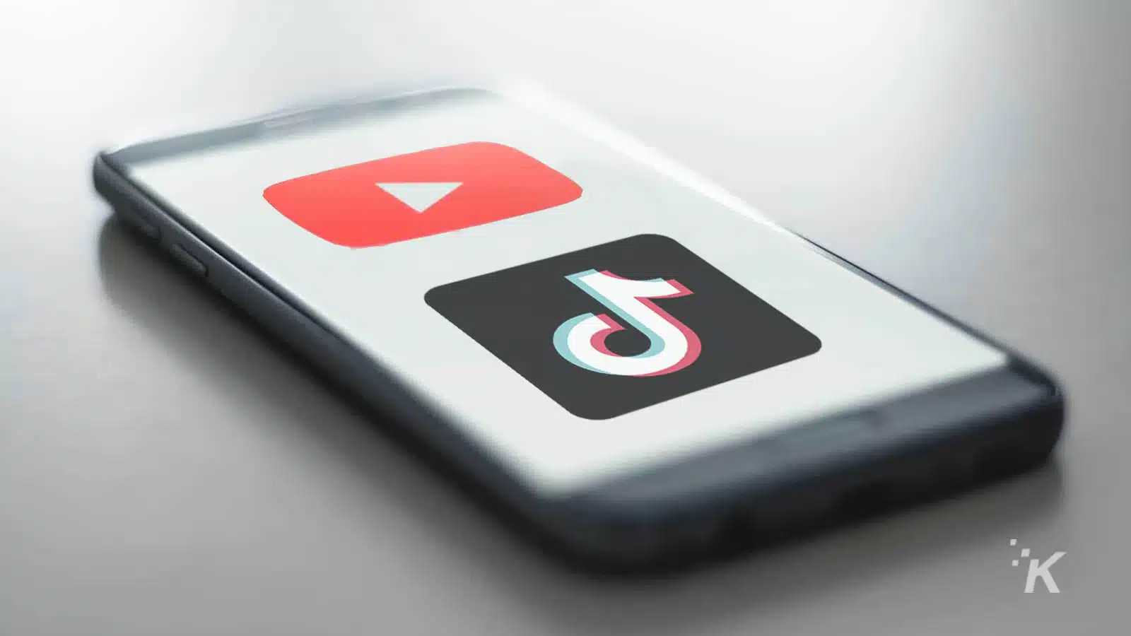 youtube and tiktok logos on phone